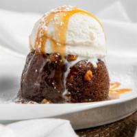 Toffee Nut Cake · Warm sticky toffee nut cake with a praline pecan sauce topped with vanilla bean ice cream.