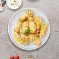 Cheesy Clove Wings · Fresh chicken wings fried until golden brown, and tossed in garlic and parmesan. Served with...