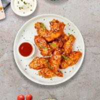 Sweet Zing Wings · Fresh chicken wings fried until golden brown, and tossed in sweet and sour sauce. Served wit...
