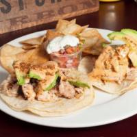Fish Tacos · Grilled wild fish of the day, corn tortillas, avocado, slaw, and house sauce.