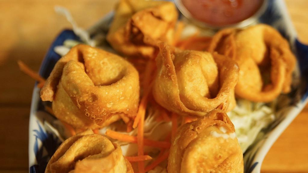 Crab Rangoon · Deep fried egg wonton stuffed with crab meat and cream cheese. Served with sweet and chili sauce.