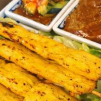 Satay Chicken · Skewer grilled and marinated chicken breast. Served with cucumber salad and peanut sauce.