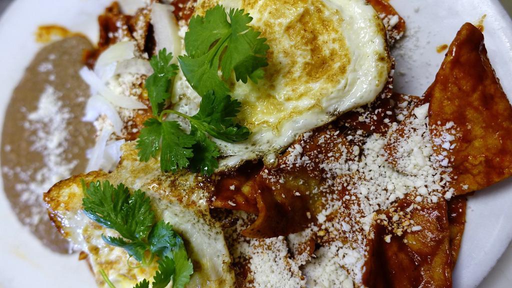 Chilaquiles in Red Guajillo Chile Sauce & Eggs · 2 free range eggs. Topped with onions and Queso Fresco. Serve with refried beans.