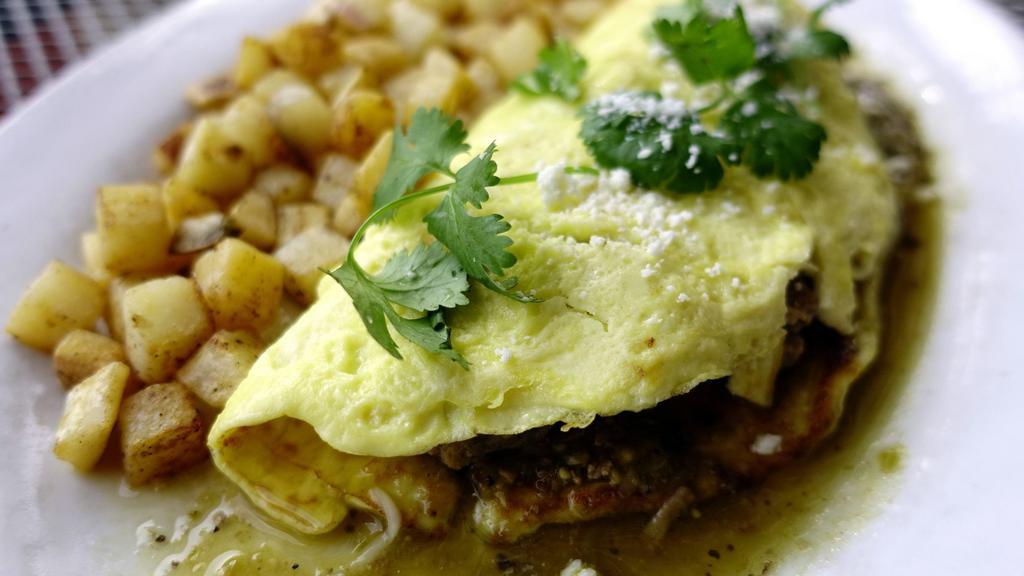 Chile Verde Omelette · Three free range eggs stuffed with spicy green pork chile verde. Choice of tortillas. Grilled red potatoes & Black beans.