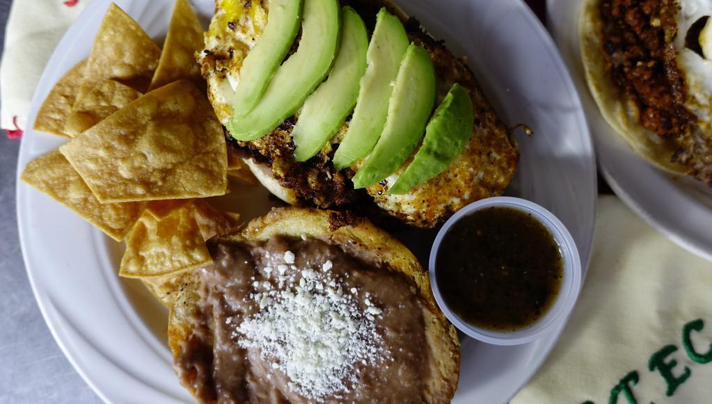 Breakfast Torta · Toasted bolillo, refried beans, chorizo or bacon, red potatoes, sliced avocado, Queso Fresco topped with a fried egg.