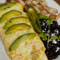 Carnitas Omelette · Three free range eggs stuffed with our housemade Carnitas. Choice of tortillas. Red potatoes...