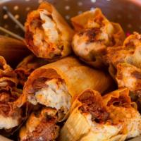 Tamales family meal · 12 hand made Tamales in corn husk. 4 chicken, 4 pork and 4 vegetarian. Tomato rice, beans, s...