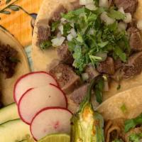 Organic corn tortillas Taco · Organic corn tortillas, choice of meat, topped with cilantro and onions.
