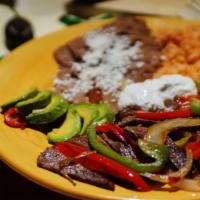 Fajitas · Beef, chicken breast or shrimp. Choice of tortillas. Choice of beans. Serve with tomato rice...