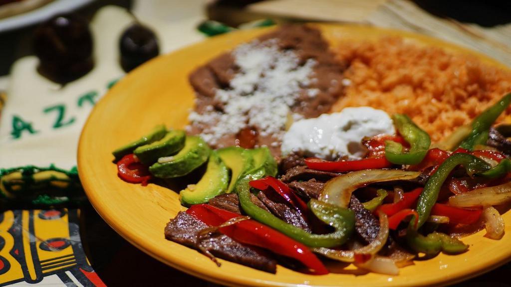 Fajitas · Beef, chicken breast or shrimp. Choice of tortillas. Choice of beans. Serve with tomato rice, sour cream, lettuce, and guacamole.