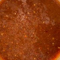 Salsa Pastor - Medium heat · Roasted chile de arbol, tomatillos. Blended with cilantro and onions.
