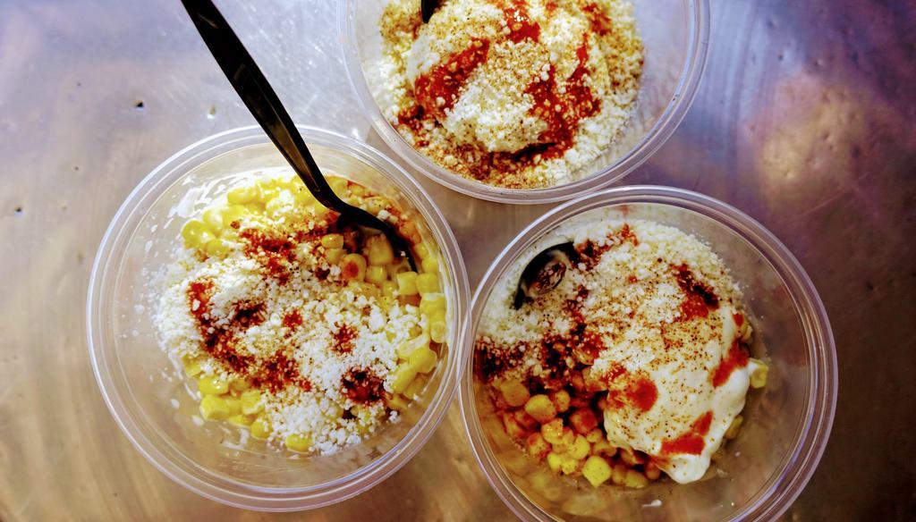 Esquites en vaso · Mexican street corn in a cup. Sweet corn, mayo, lime juice, Cotija cheese and chile powder.