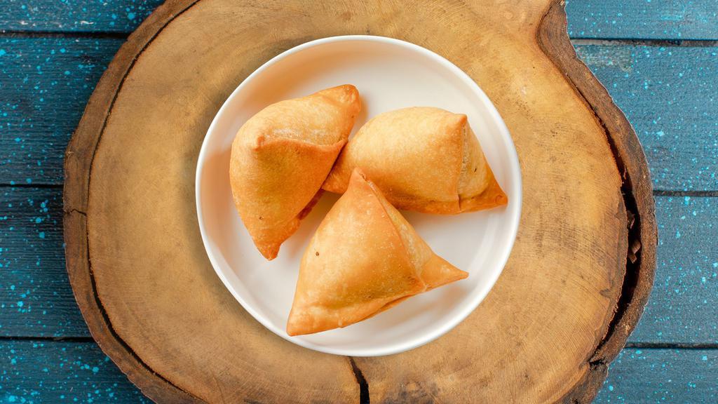Smooth Samosa · Vegetables mixed in a curry marinate & fried in a crispy wheat layer. Served with tamarind chutney.