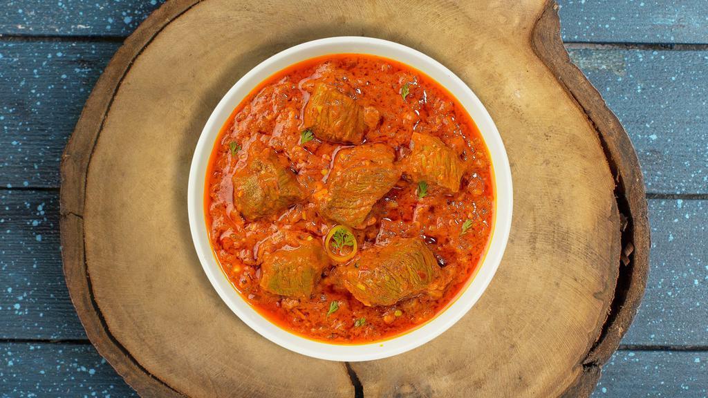 Gongura Goat Curry · Goat cooked in a tomato based onion gravy with freshly ground spices.