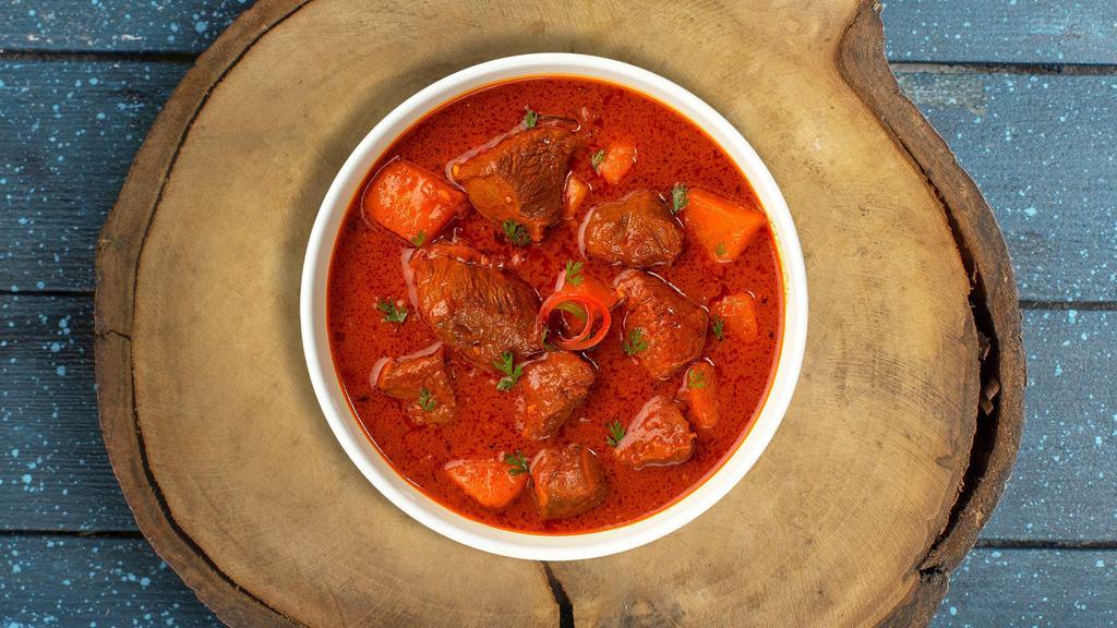 Greatest Goat Vindaloo · Goat cooked in a spicy pungent curry with potatoes.