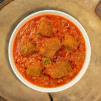 Nizami Goat Curry · Goat cooked in a tomato based onion gravy with freshly ground spices.