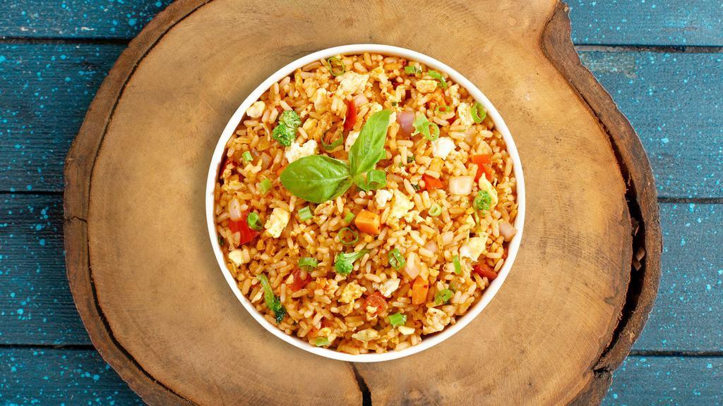 Chicken Fried Rice · Indo-Chinese fried rice cooked with chicken, egg, vegetables, soya sauce, chili sauce and chili vinegar.