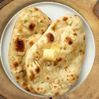 Garlic Geek Naan · Freshly baked bread in a clay oven garnished with garlic and butter