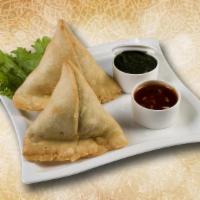 Triangular Spiced Dumpling · Fried  pastry with a savory filling of spiced potatoes, onions, peas.