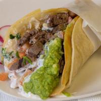 Taco Super · Meat, Melted Cheese, Whole Pinto Beans, Sour Cream & Guacamole.