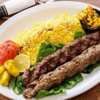 Persian Beef Kebab (Kubideh) · Two skewers of grass fed beef kebabs,  fire roasted tomatoes and basmati rice.