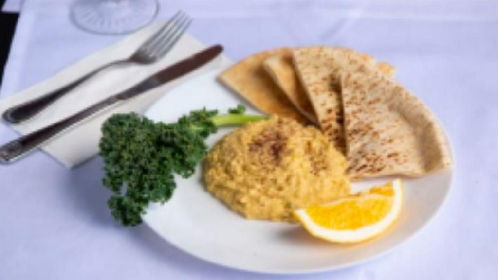 Hummus & Pita Bread · Traditional chickpea dip, whipped with a touch of lemon juice & Tahini served with warm pita bread