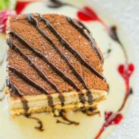 Tiramisu · Lady fingers soaked in espresso and brandy, layered with mascarpone cream and topped with co...