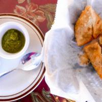 Vegetable Samosas · Two crisp and spiced vegetable puffs filled with potatoes and peas.