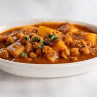 Chana Masala · Garbanzo beans cooked with onions, fresh tomatoes, and spices, north Indian style.