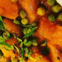 Aloo Mattar · Potatoes and green peas cooked in a curry sauce.