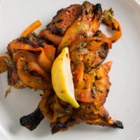 Tandoori Chicken · Chicken marinated in yogurt and spices and baked in a clay oven.
