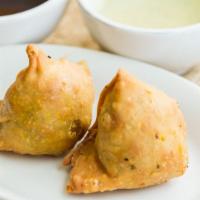 Vegetable Samosa · Handmade deep-fried turnovers stuffed with mildly spiced potatoes & peas. Served with mint &...