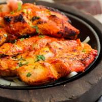 Tandoori Chicken · Chicken marinated in herbs and a blend of spices and grilled in a tandoori clay oven.