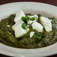 Palak Paneer · Tender cubes of paneer sautéed in slow-cooked spinach and flavored spices.