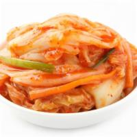 Kim Chi · Napa cabbage mixed with fermented vegetables and blended with herby spices.