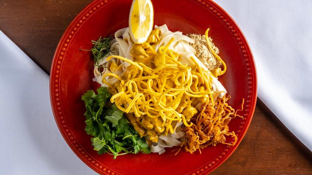 House Special Noodle · Burmese special. Flat noodle with coconut chicken, lime leaves, yellow pea's powder, onion and fried thin noodle on the top.