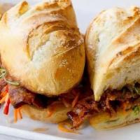 SPICY PORK SANDWICH · toasted baguette, gochujang marinade, pickled vegetables, roasted scallion aioli, root veget...