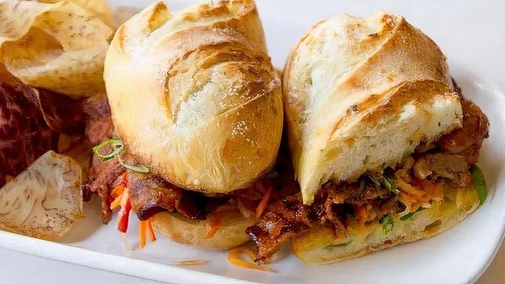 SPICY PORK SANDWICH · toasted baguette, gochujang marinade, pickled vegetables, roasted scallion aioli, root vegetable chips