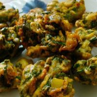 Palak Pakora · Spinach coated with garbanzo batter with spices and deep fried.