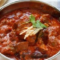 69. Lamb Gushane · Lamb cooked with bell peppers, onions, peas & mushrooms in curry sauce.
