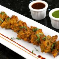 Vegetable Pakora · Cubes of mixed vegetable fried dumplings made with garbanzo bean flour and fine herbs.