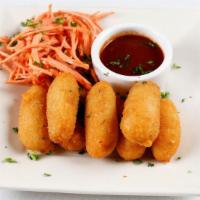 Croquetas · crispy potato fritters with manchego cheese, carrot slaw, side of tamarind-smoked jalapeno B...