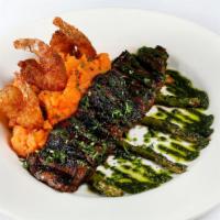 Tierra y Mar · marinated skirt steak, coconut crusted shrimp, sofrito mashed potatoes, grilled asparagus, a...
