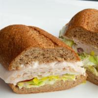 Turkey Sandwich · Served with mayonnaise, mustard, lettuce, tomatoes, onions, pickles, peppers, and jalapenos.