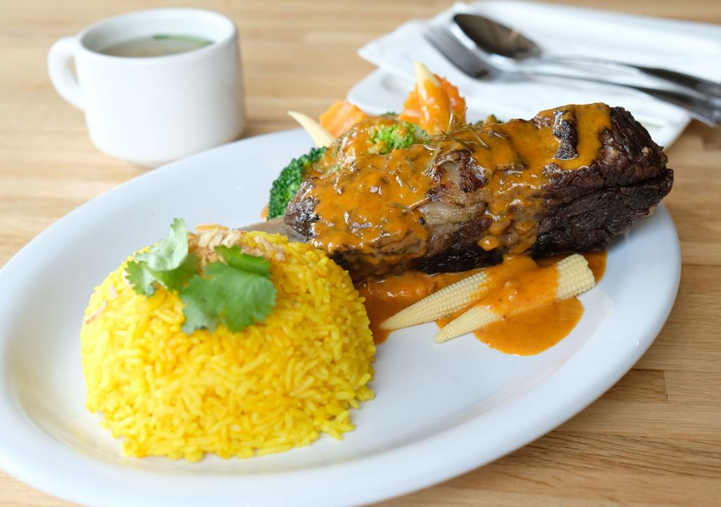 Panang Braised Beef Short Rib · Topped with Panang curry sauce, served with steamed assorted vegetables and Thai-curried rice.
