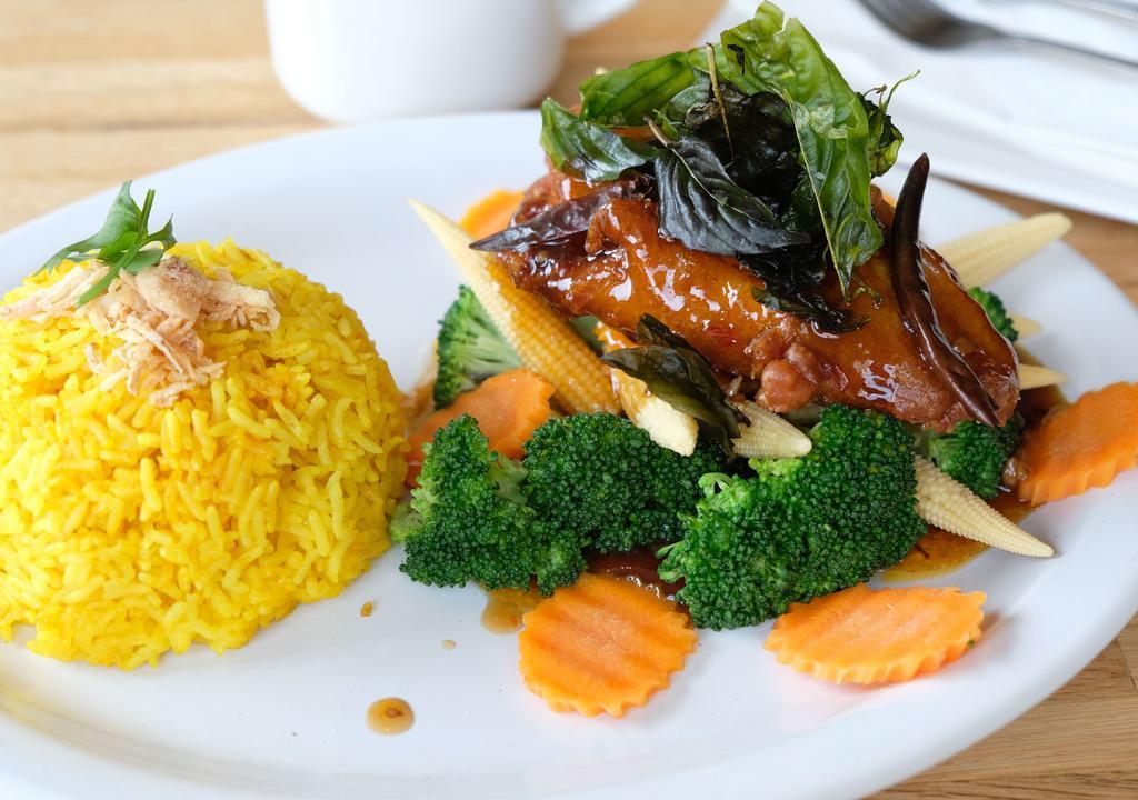 Garlic Chili Tilapia · Battered filet tilapia topped with Chaiya garlic-chili sauce, served with steamed assorted vegetables and Thai-curried rice.