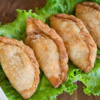 Taro Puff · Taro paste in flaky puff pastry, served with peanut sauce and cucumber salad.