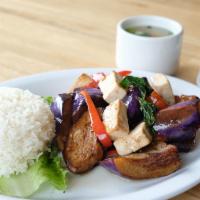 Eggplant (served with jasmine rice) · In a wok - Eggplant, bell pepper and basil with basil sauce.