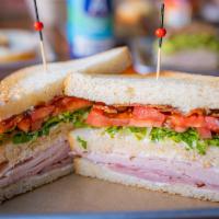 Club Classic · Smoked Turkey, Black Forest Ham, Bacon, Lettuce, Tomato, Mayonnaise, and Acme Pain De Mie.