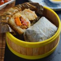 Deluxe Steamed Sticky Rice Wrap · Dried scallops, chicken, mushrooms, and sweet sticky rice wrapped in Lotus leaves.
